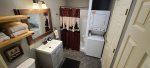 Remodeled bathroom with washer and dryer and walkin shower